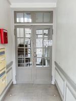 a large white door in a white room with at Le Raphaëlle - Compiègne centre in Compiègne