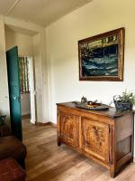 a room with a wooden cabinet and a painting on the wall at Le Clos des Laurons in Nyons