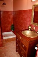 a bathroom with a sink and a bath tub at Le Clos des Laurons in Nyons