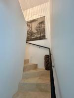 a staircase with a picture of palm trees on the wall at Villa Einigriv in Châtelaillon-Plage