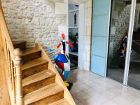 a scooter is standing next to a stair case at Villa Einigriv in Châtelaillon-Plage