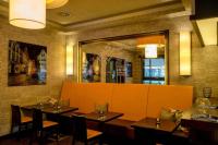 a restaurant with tables and chairs and a large mirror at Hotel Hohenstaufen in Koblenz