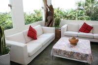 a living room with two white couches and a table at The Blue Lagoon B&amp;B in Fengbin