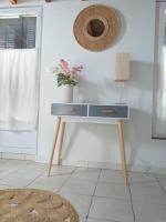 a table with a vase of flowers on it in a room at Maisonette avec jardinet sur le bas du Faron in Toulon