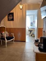 a living room with a chair and a table at ila’s tiny house in Limoges