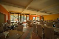 een restaurant met houten tafels en stoelen en ramen bij Life Resort Quy Nhon in Quy Nhon