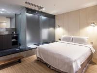 a bedroom with a large bed and a glass shower at Hotel Relax I in Taipei