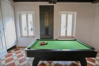 a green pool table in a room with two windows at Crazy Villa Champs Corons 61 - Interior heated pool - 2h from Paris - 30p in Les Menus