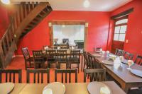 a dining room with red walls and wooden tables and chairs at Crazy Villa Champs Corons 61 - Interior heated pool - 2h from Paris - 30p in Les Menus
