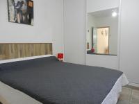 a bedroom with a large bed and a mirror at L&#39;Oliveraie in Draguignan