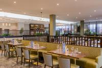 a restaurant with tables and chairs and a library at Hotel Killarney in Killarney
