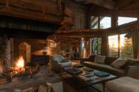 a living room with a couch and a fireplace at Zannier Hotels Le Chalet in Megève