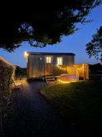 a tiny house with lights on it at night at Sheelin Huts Blue, Hot-tub available From 1st April until 1st November in Cavan