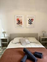 a bed in a bedroom with three pictures on the wall at La Réal - Apt 2 chambres rénové in Perpignan