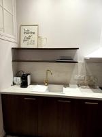 a kitchen with a sink and a counter top with a picture at La Réal - Apt 2 chambres rénové in Perpignan