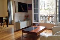 a living room with a coffee table in front of a window at Magnifique appartement de charme au cœur de Paris in Paris