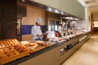 two chefs are preparing food in a bakery kitchen at ANA Crowne Plaza Narita by IHG in Narita