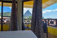 a bedroom with a bed and a view of a mountain at Sea Piton View Apartment- Location, Convenience, Modern Living in Soufrière