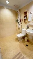 a bathroom with a toilet and a sink at Kindness Hotel - Tainan Minsheng in Tainan