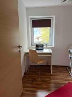 a desk with a chair in a room with a window at Large 8 Bed Apartment. Perfect Location. in Stuhlfelden