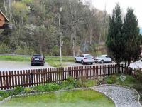 two cars parked in a parking lot next to a fence at Large 8 Bed Apartment. Perfect Location. in Stuhlfelden