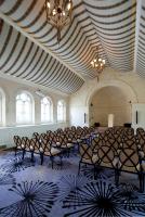 an empty room with chairs and a ceiling with chandeliers at The Gainsborough Bath Spa - Small Luxury Hotels of the World in Bath