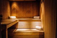 a sauna with two steps in a wooden room at Zannier Hotels Le Chalet in Megève