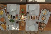 a table with plates of food on top of it at AlaBora Hotel in Alacati