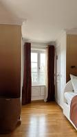 a bedroom with a bed and a window and wooden floors at Amazing view on the Versailles Palace - Paris 15min in Versailles