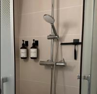 a shower in a bathroom with two bottles on the wall at Amazing view on the Versailles Palace - Paris 15min in Versailles