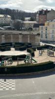 a courtyard with tables and benches in a city at Amazing view on the Versailles Palace - Paris 15min in Versailles