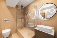 a bathroom with a shower and a toilet and a mirror at Soubise in Paris