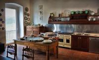 a kitchen with a stove and a table in it at Resort Nuvola Srls in Ripabottoni