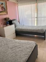 a bedroom with two beds and a dresser and a window at Appartement panoramique sur mer in Toulon