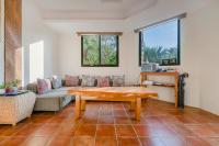 a living room with a couch and a table at Southern Sun Homestay North in Kenting