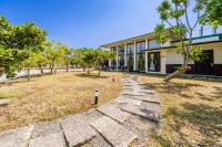 a stone path in front of a building at Southern Sun Homestay North in Kenting