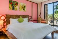 a bedroom with a white bed and a pink wall at Southern Sun Homestay North in Kenting