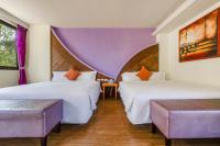 two beds in a room with purple curtains at Southern Sun Homestay North in Kenting