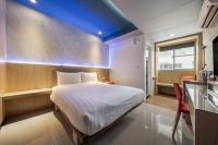 a bedroom with a bed with a blue ceiling at S&amp;E Hotel in Tainan