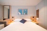 a bedroom with a large white bed and a mirror at Hotel A&#39;mare in Zadar