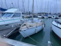 a group of boats docked in a harbor at Nuit insolite dans un petit voilier in La Rochelle