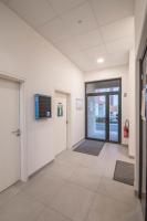 an empty hallway of an office with doors and rugs at Elodie - T2 proche gare in Le Mans