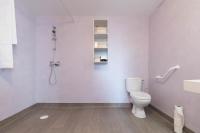 a bathroom with a white toilet and a shower at Pierrick - Studio wifi et gare in Le Mans