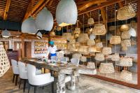a woman standing at a table in a restaurant at Zuri Zanzibar in Kendwa