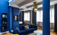 a living room with blue walls and a blue couch at ABode Manchester in Manchester