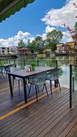 a picnic table and two benches on a wooden deck at Waterside SPA Hotel in Ognyanovo