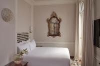 a bedroom with a white bed and a mirror on the wall at Violino d&#39;Oro Venezia in Venice