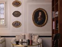 a living room with a portrait of a woman on the wall at Violino d&#39;Oro Venezia in Venice