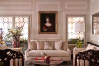 a living room with a couch and a portrait of a woman at Violino d&#39;Oro Venezia in Venice