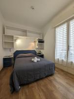 a bedroom with a bed with two towels on it at Les Palmiers in Fréjus